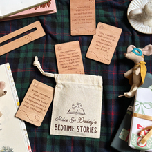 Wooden cards with bedtime stories on a plaid fabric background with a bag labeled 'Miles & Daddy's Bedtime Stories'.