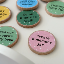 A collection of colourful wooden activity tokens for new dads and babies displayed on a white tray. Each eco-friendly token features bonding prompts such as “Tummy time fun,” “Read our favourite story book,” and “Capture sweet & silly family photos together.” Part of a heartfelt Father's Day gift set designed to inspire memory-making moments between Daddy and baby.