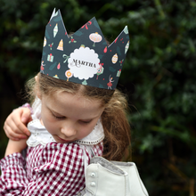 Child wearing a Nutcracker design paper crown with 'Martha' printed on.